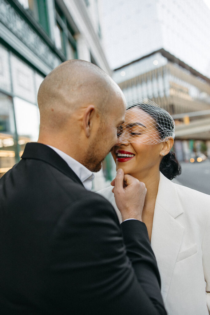 Man caressing his brides face during their downtown Detroit elopement photos. 