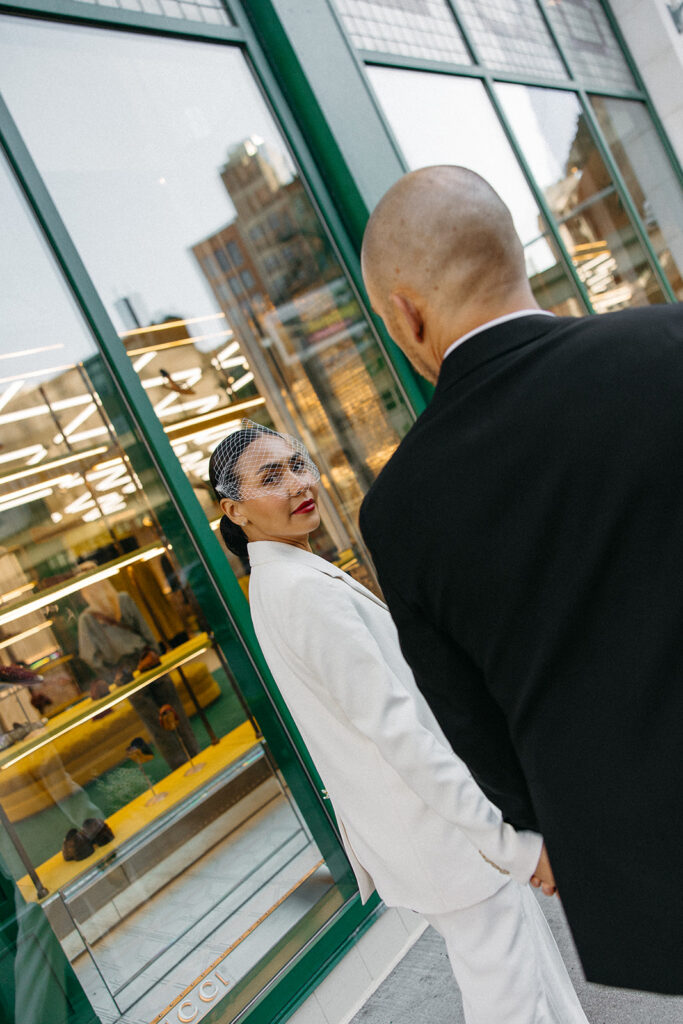 Bride and groom walking together in downtown Detroit for their elopement photos.