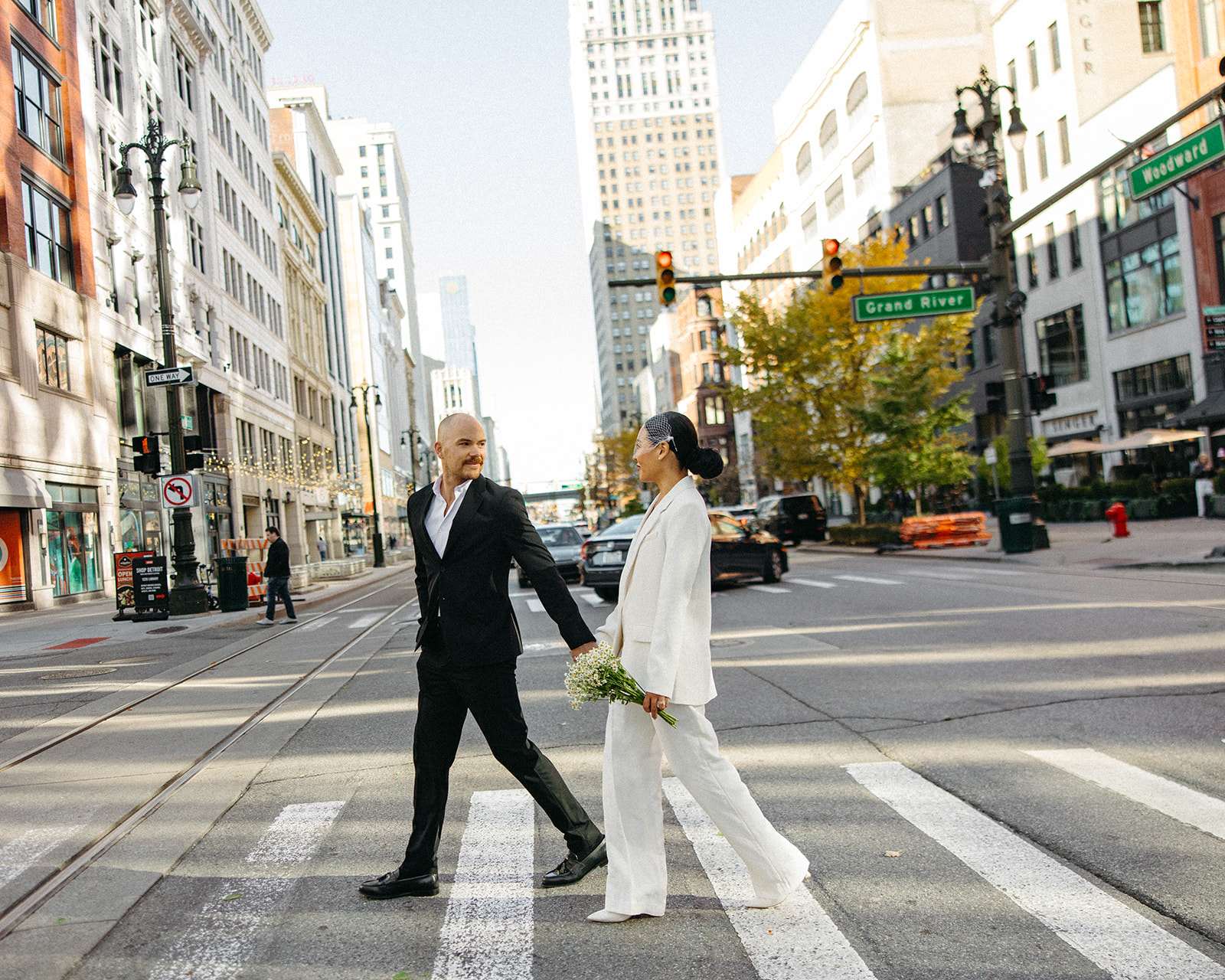 Couple walking downtown for their Detroit elopement photos.
