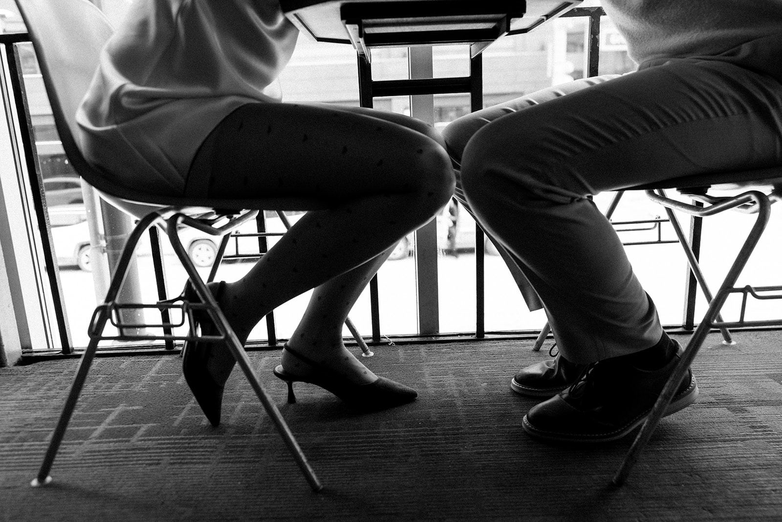 Close up black and white shot of a couple sitting at a table together at SPKRBOX in Detroit.