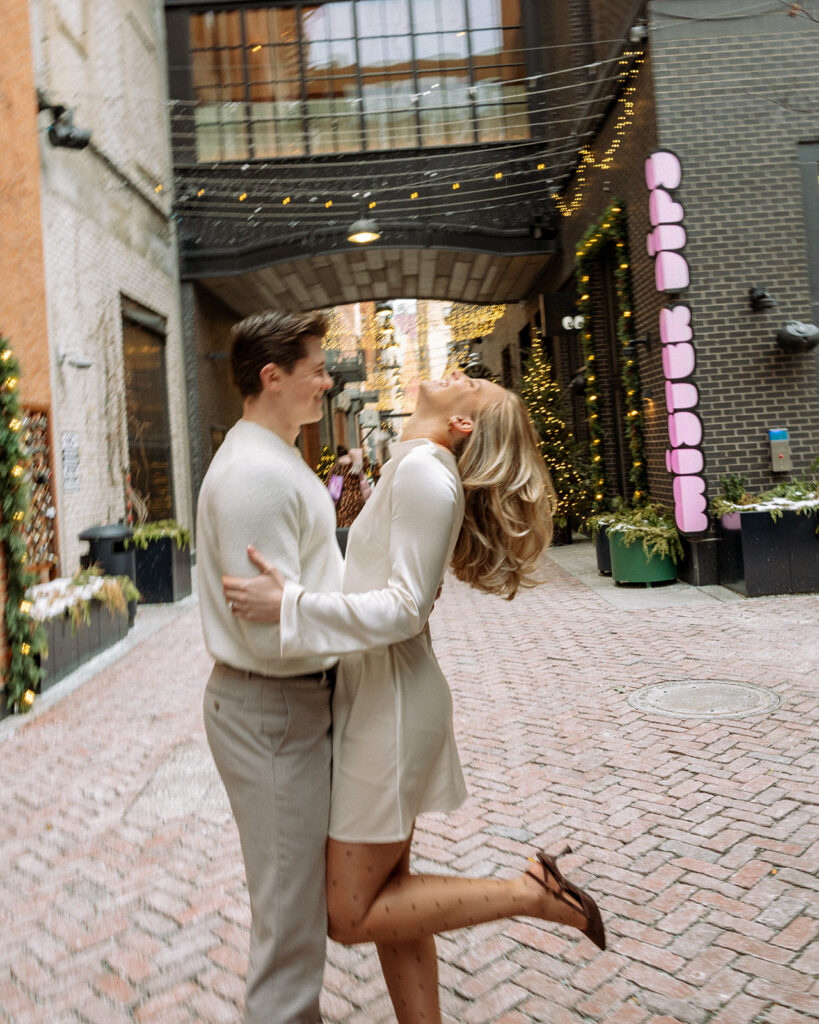 Couple standing together in a brick alley in downtown Detroit during their engagement session.
