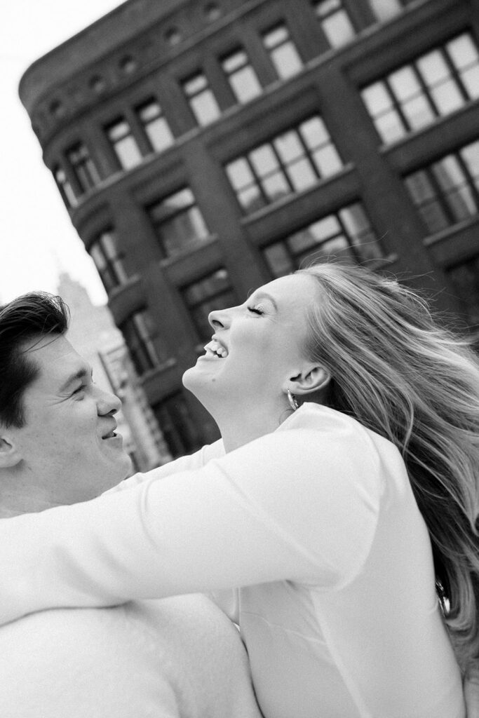 Black and white close up of a couples candid downtown Detroit engagement photo on a rooftop.
