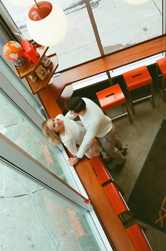 Overhead shot of a couple posing at SPKRBX in Detroit, captured on film.