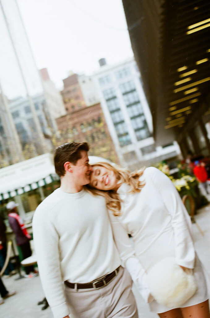 Film engagement photo of a couple walking downtown Detroit.