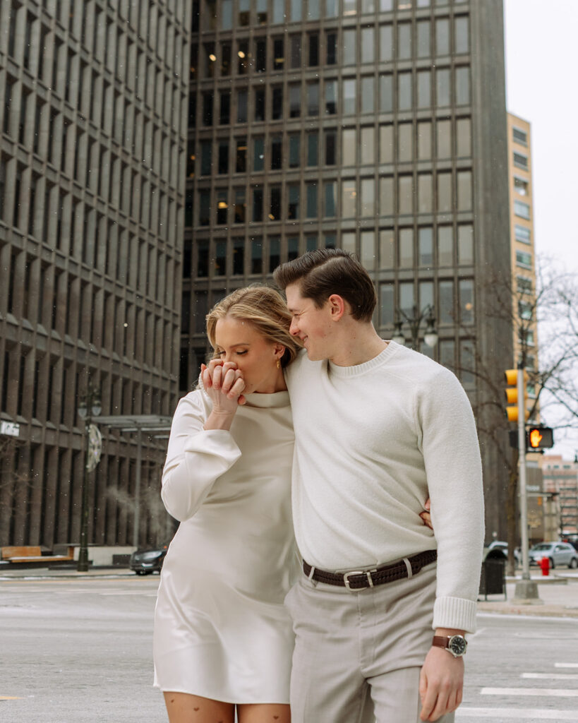 Couple sharing a quiet moment together on a downtown Detroit street corner in winter.