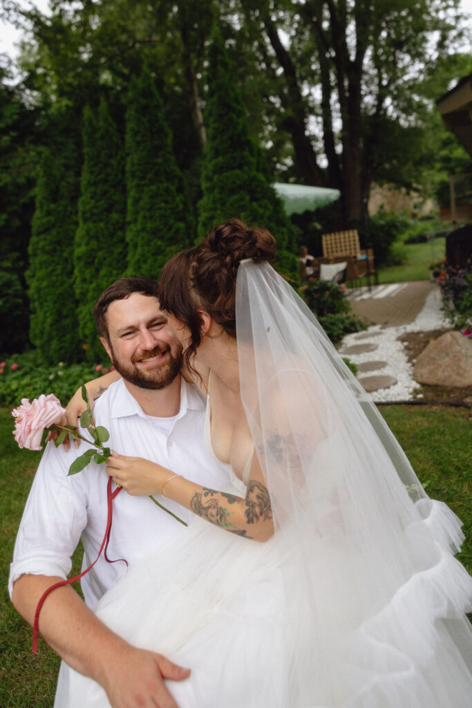 Couple posing for photos in their backyard during their Michigan micro wedding.