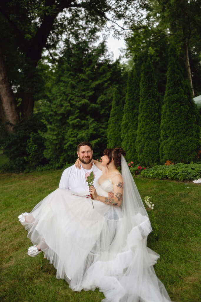 Couple posing in their backyard for their Michigan micro wedding portraits.