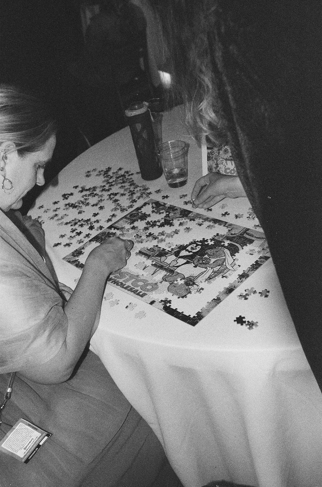 Wedding guest working on puzzle at reception table during relaxed documentary wedding in Michigan on film.