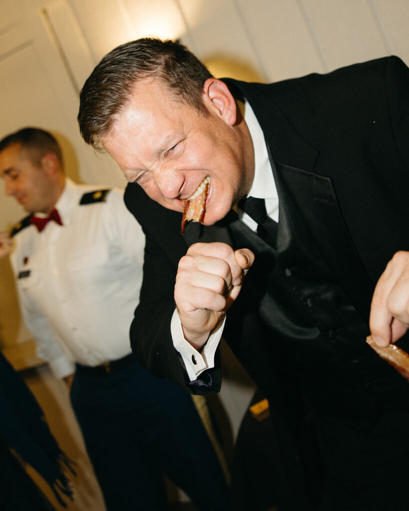 Guest enjoying bacon during a Michigan wedding reception.