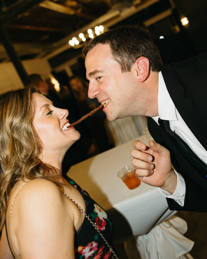 Guests enjoying bacon during a Michigan wedding reception.