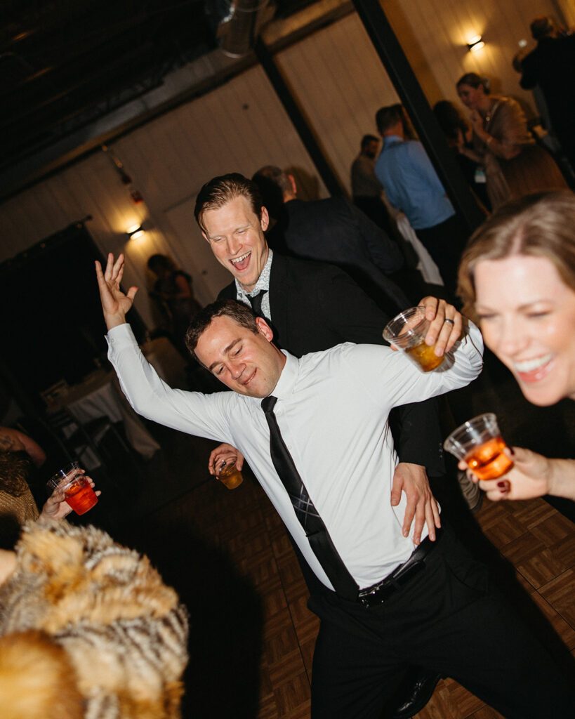 Guests dancing and celebrating together during high-energy wedding reception.