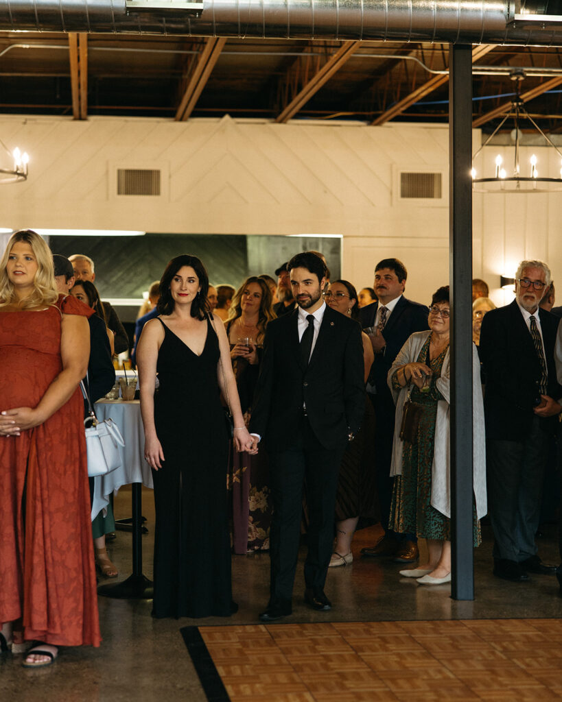 Guests listening to speeches during a Michigan wedding reception in Grand Rapids.