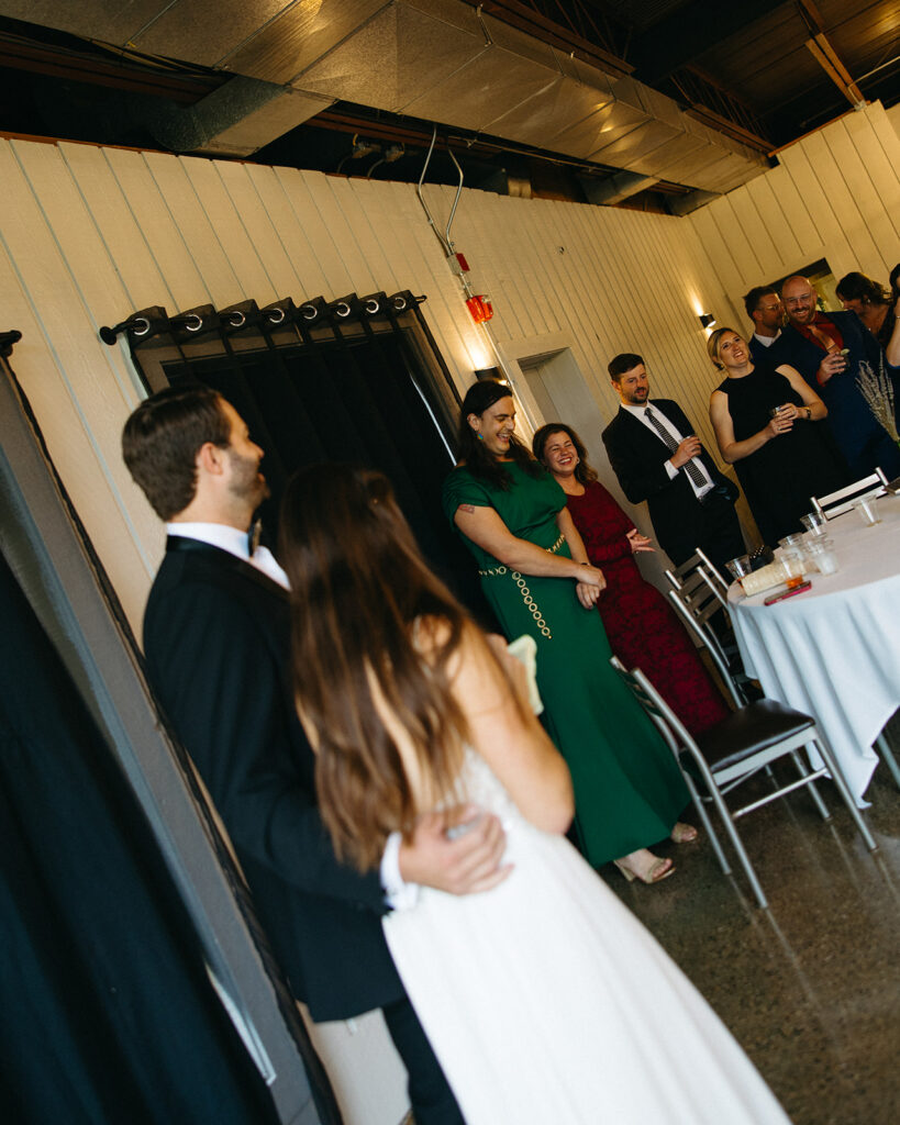Bride and groom holding one another as speeches are given during their Michigan wedding reception near Grand Rapids. 