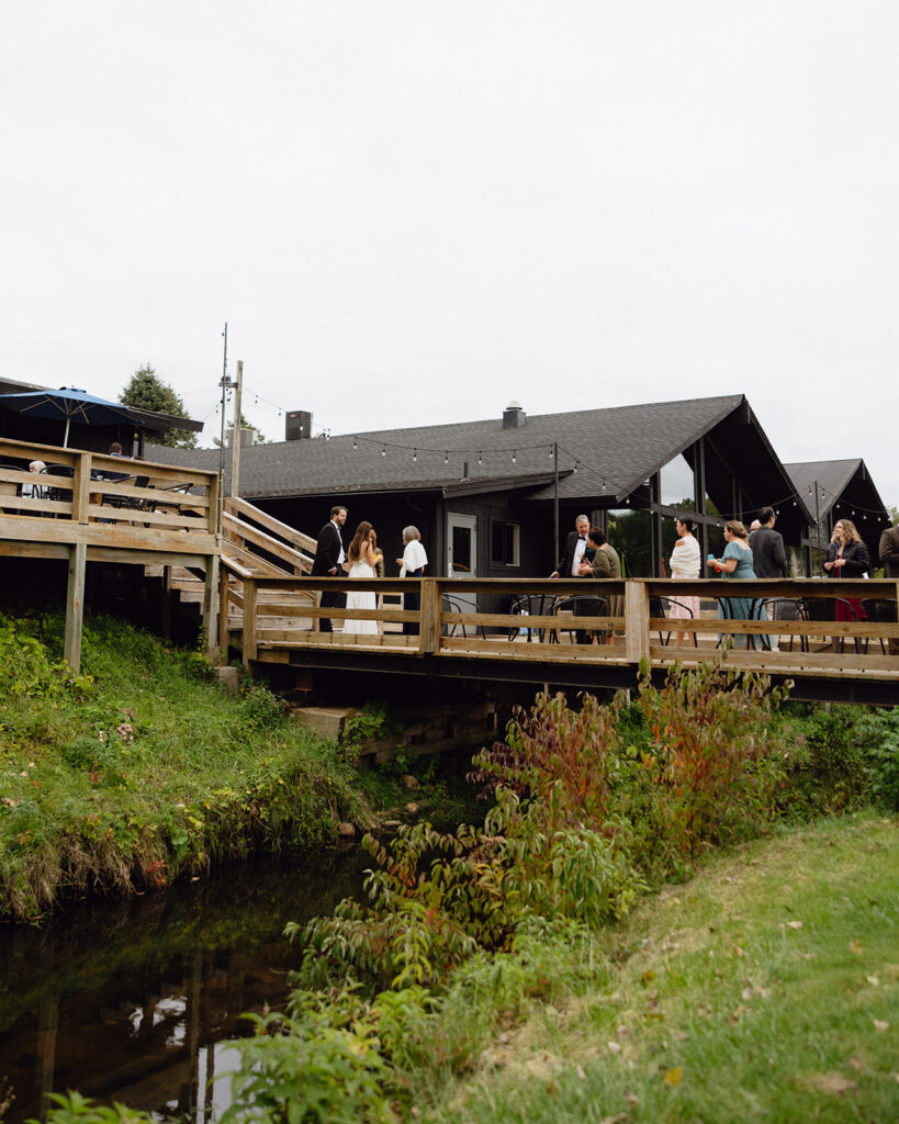 Michigan documentary wedding photo of a bride and groom mingling with their guests outdoors. 