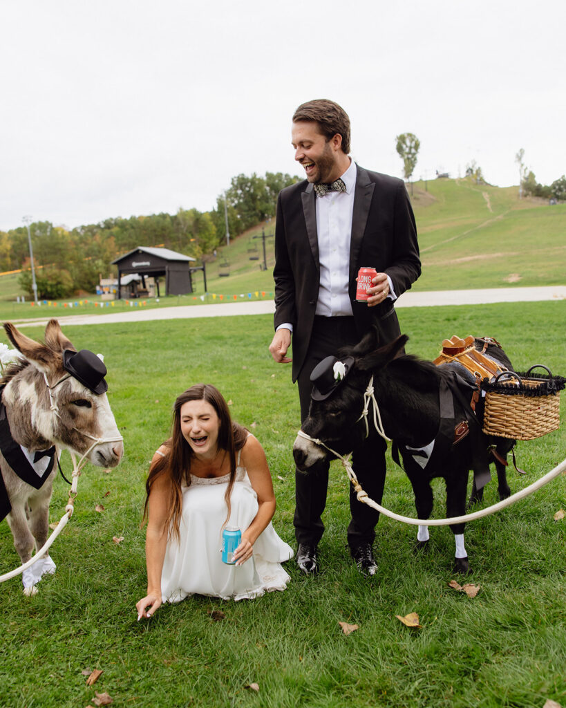 Bride and groom laughing during their Michigan documentary wedding with beer donkeys. 