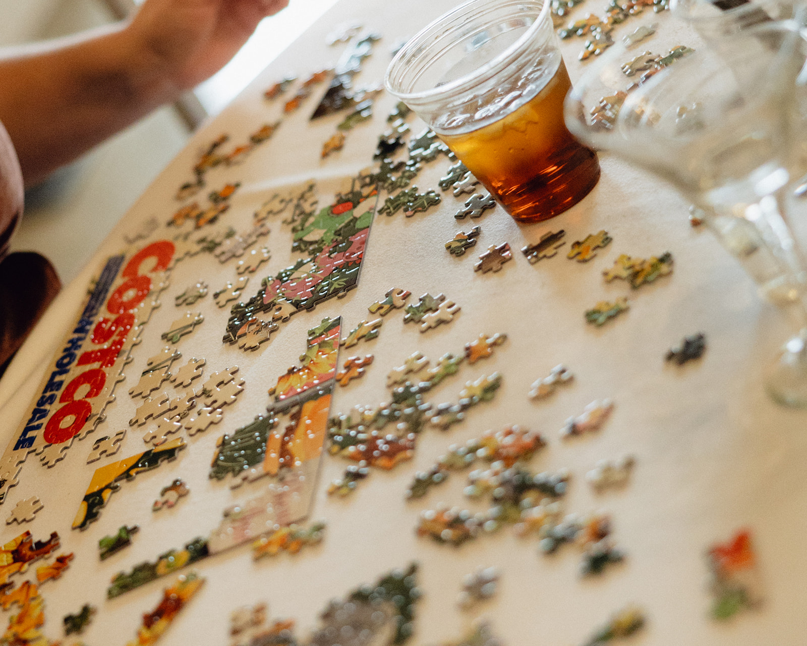 Guest working on a puzzle at a reception table during a documentary Michigan wedding near Grand Rapids.