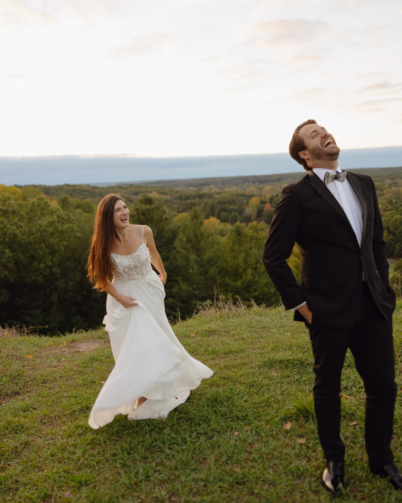 Bride and groom playing and spinning during candid sunset wedding photos.