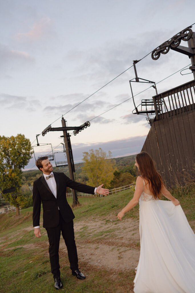 Bride and groom walking outdoors together during their Michigan documentary wedding photos. 
