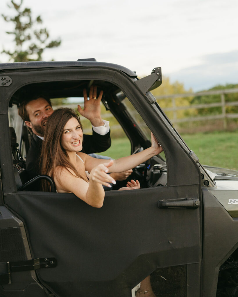 Couple riding in side-by-side vehicle during relaxed wedding day near Grand Rapids, Michigan.