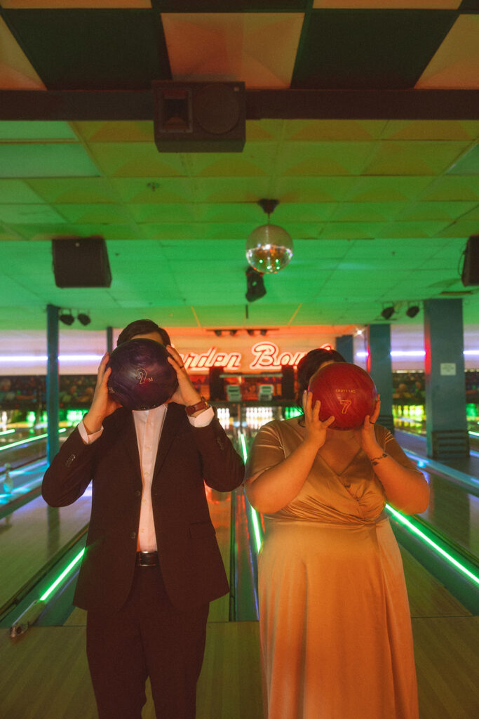 Couples Michigan elopement photos at a bowling alley.