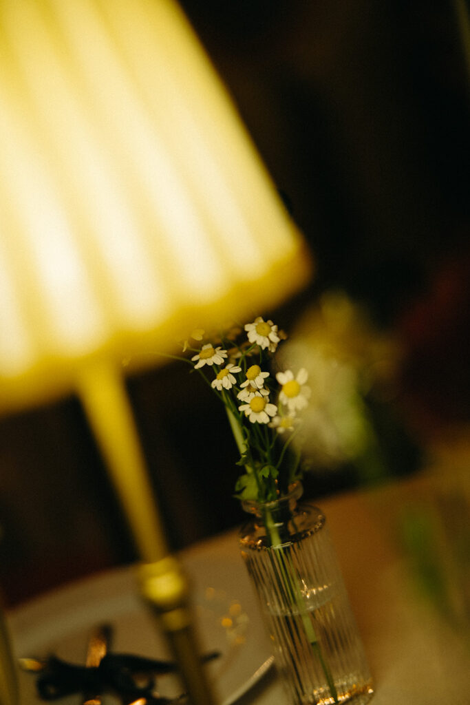 Close up of floral table detail with candlelight at Unionwood Shop Clarkston Michigan wedding.