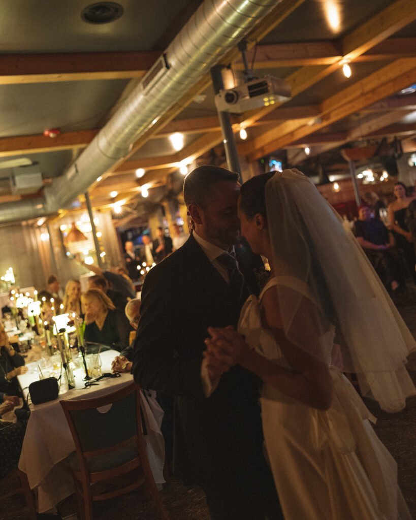 Bride and groom sharing first dance during Clarkston Michigan wedding reception at Unionwood Shop.
