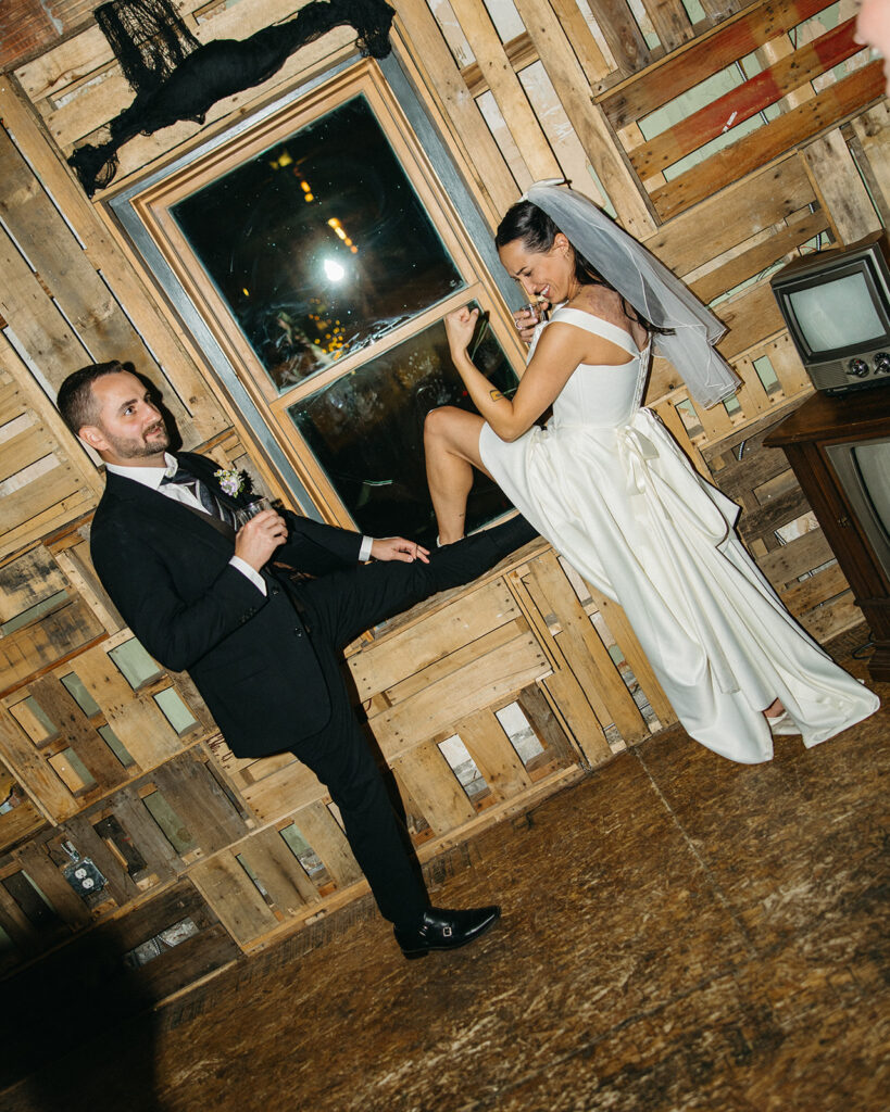 Flash photo of a bride and groom posing during their wedding reception.