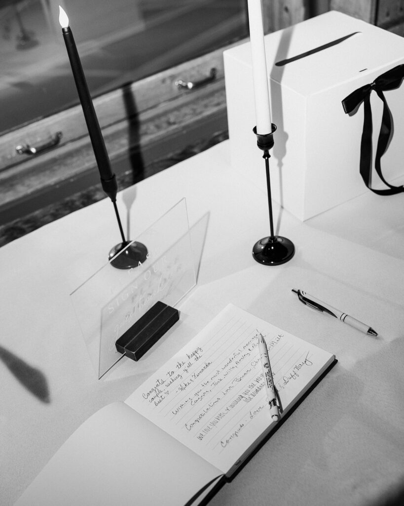Black and white photo of a wedding reception gift table.