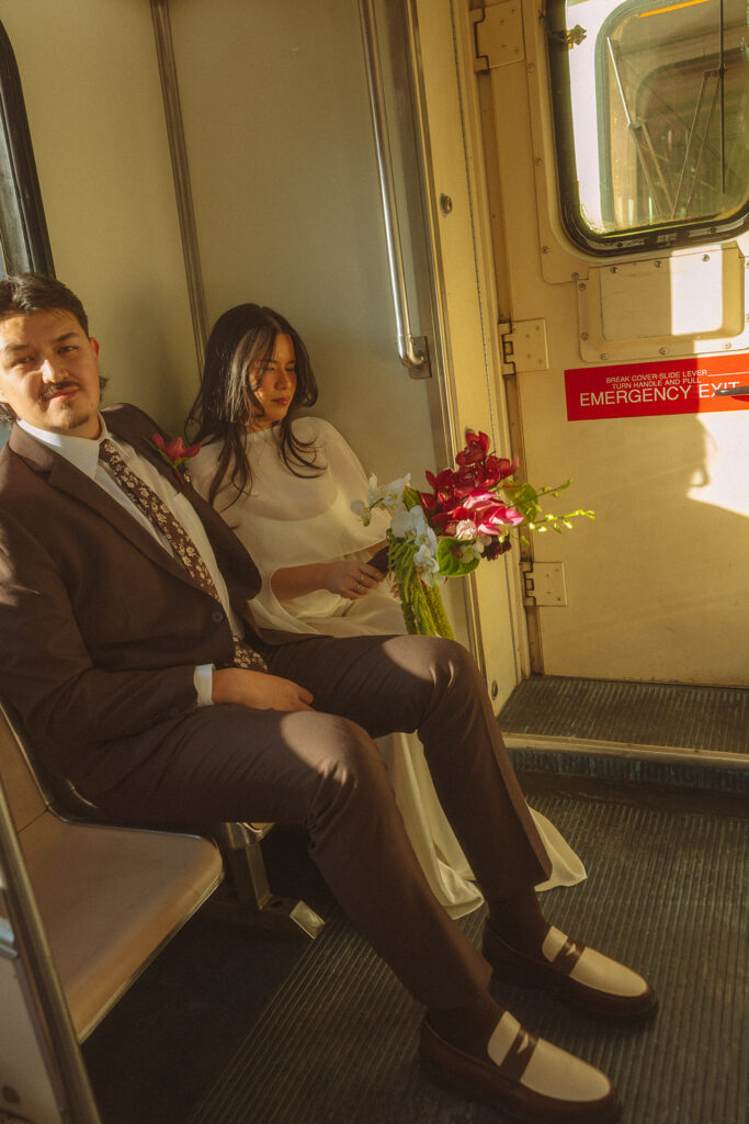 Bride and groom sitting together on the Detroit People Mover.
