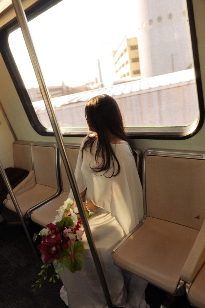 Bride sitting on the Detroit People Mover during her elopement photoshoot.