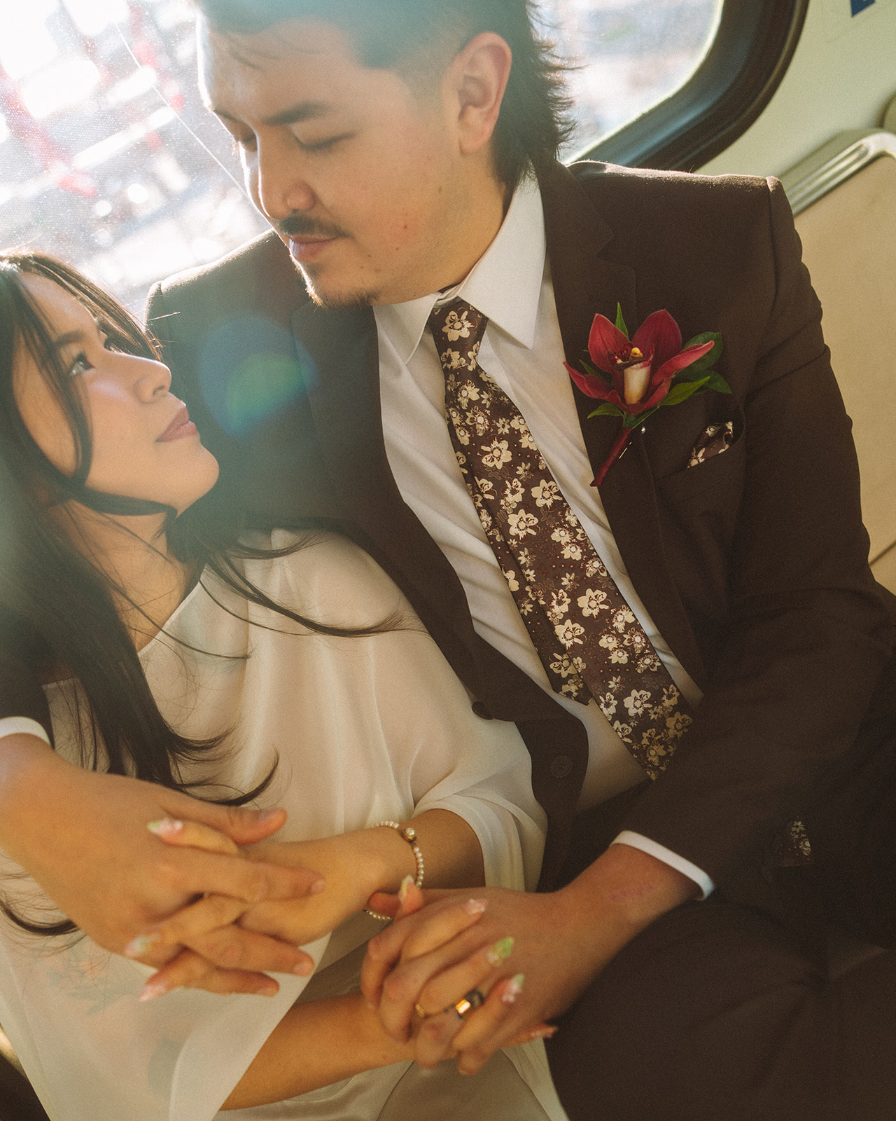 Close-up of bride and groom holding hands with soft light during downtown Detroit elopement.