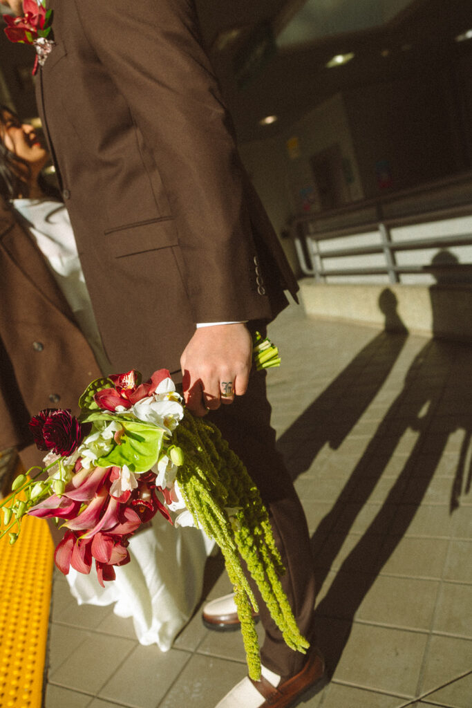 Bride and groom waiting for the Detroit People Mover on the platform.