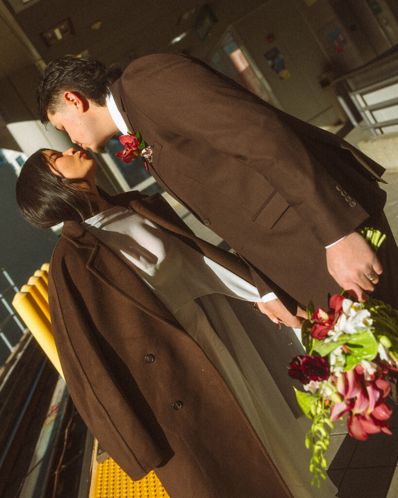 Couple kissing in the golden light on the People Mover platform.