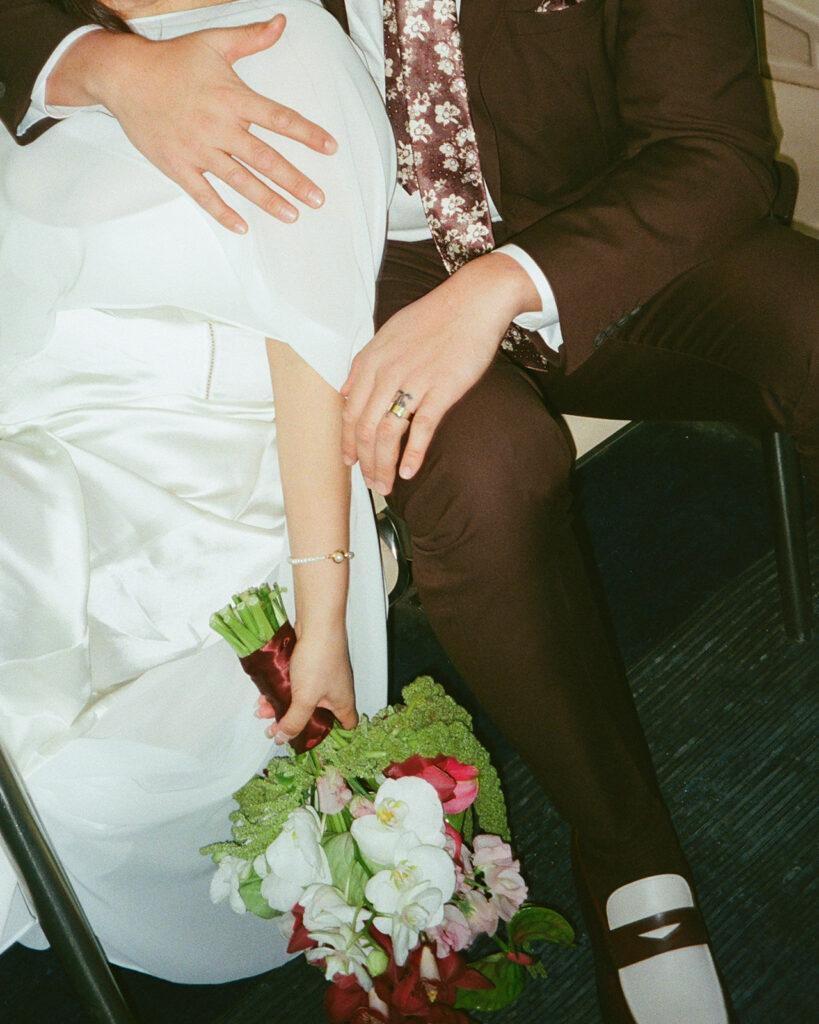 Bride and groom snuggled close together as they ride the Detroit People Mover captured on film.