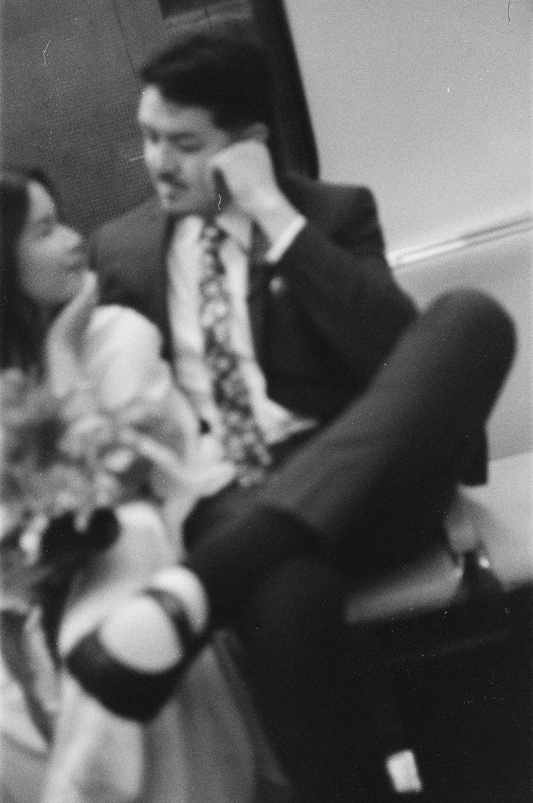  Black and white film photo of a bride and groom riding the Detroit People Mover.