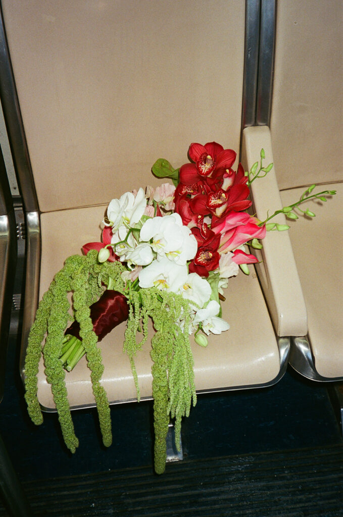 Brides bouquet resting on a seat on the Detroit People Mover captured on film.