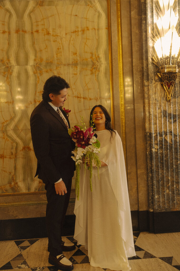 Bride and groom smiling during their Fisher Building elopement in Detroit.
