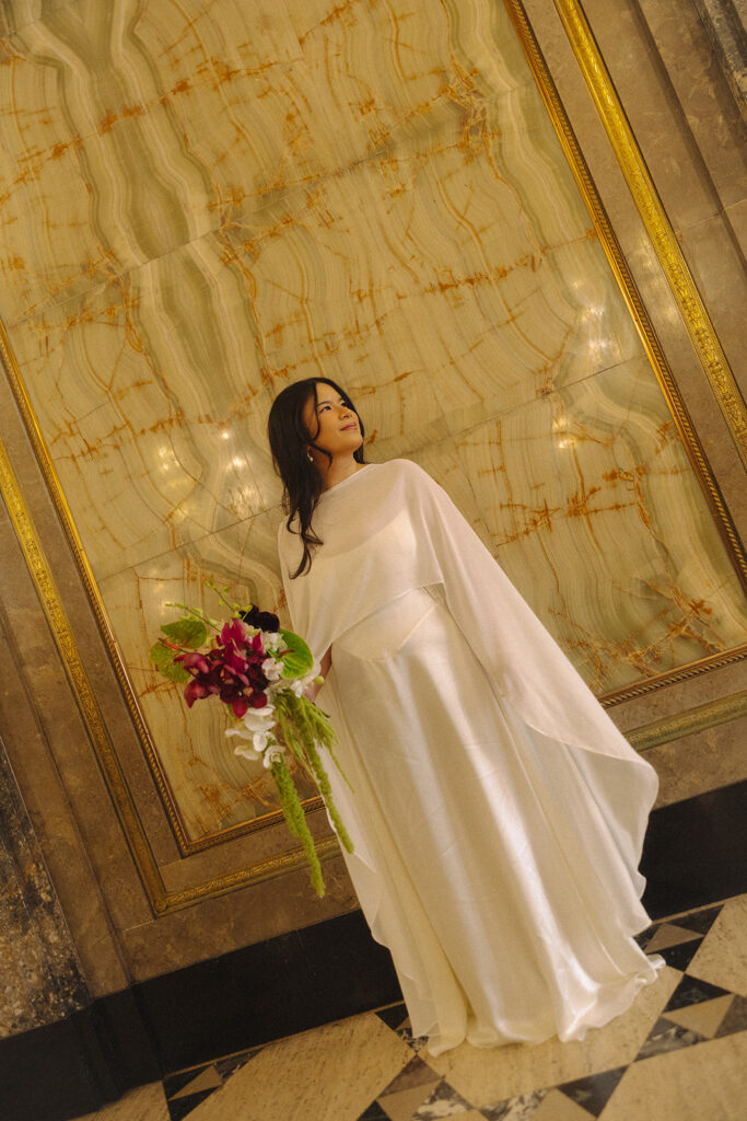 Bride posing at Fisher Building for her elopement portraits.