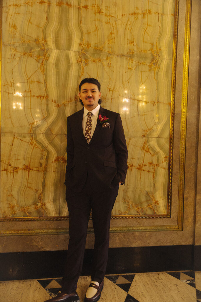 Groom posing at Fisher Building for his elopement portraits.