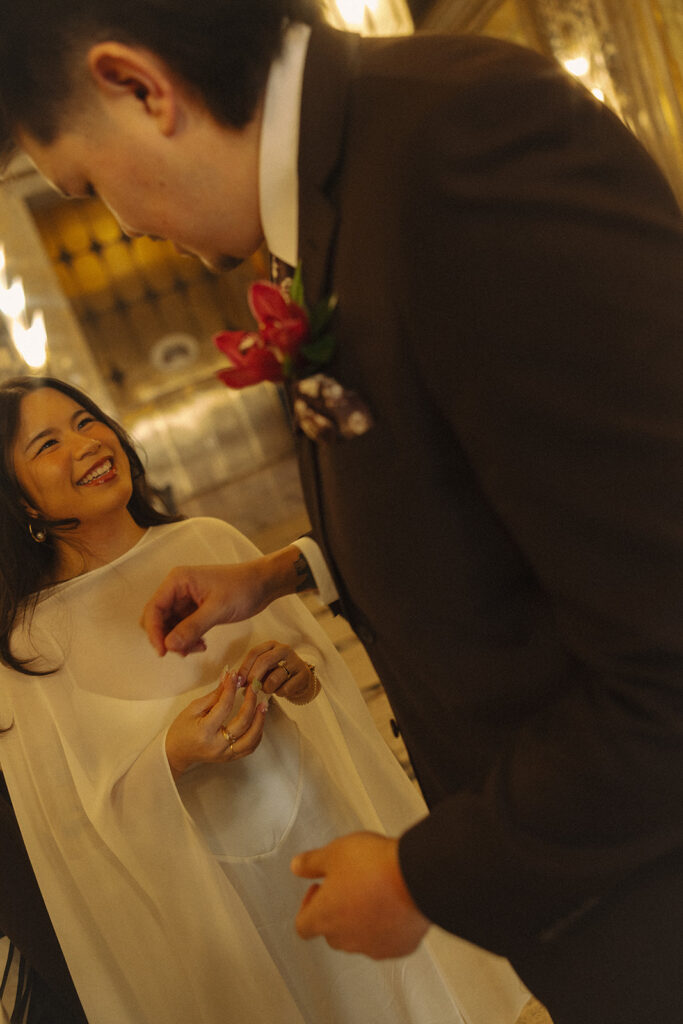 Bride smiling at her groom at Fisher Building in Detroit. 