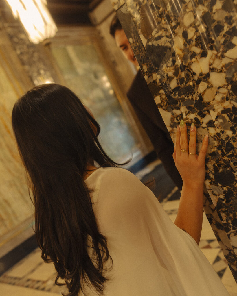 Bride and groom smiling at one another.