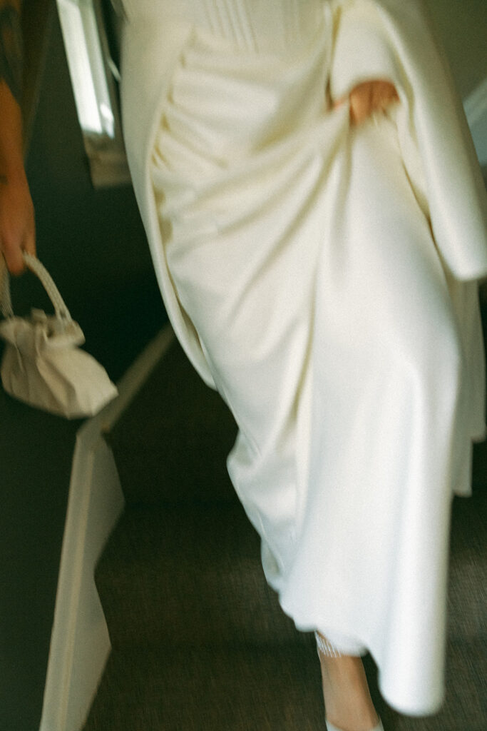 Close up shot of a bride walking down the stairs.