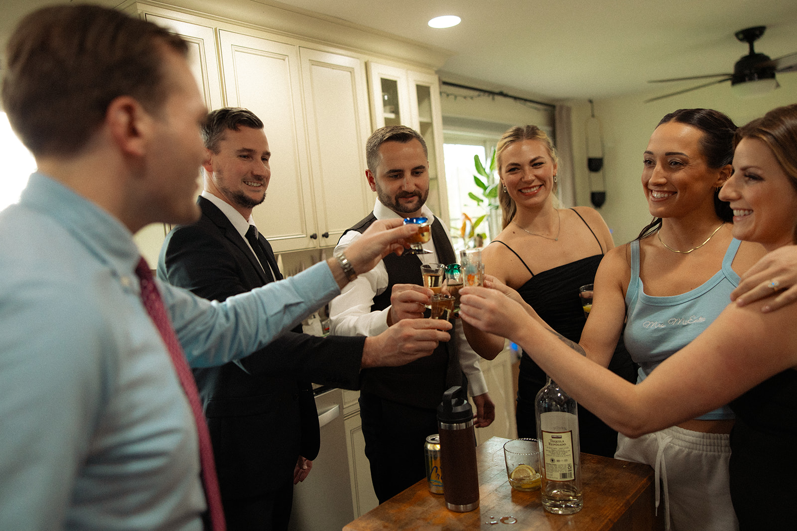 Bride and groom taking a shot with friends during getting ready at home for a Clarkston Michigan wedding.