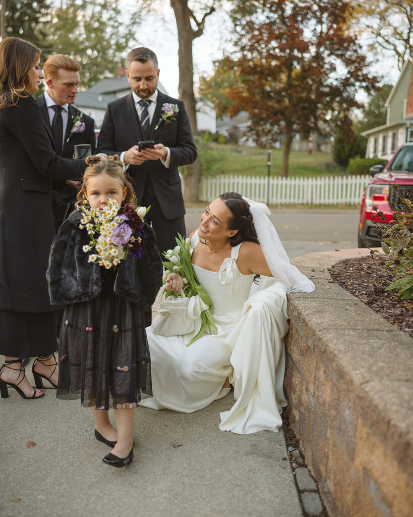 Bride talking to a little girl before her ceremony.