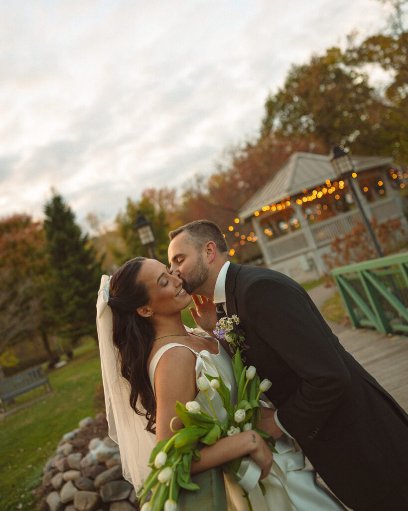 Bride and groom sharing a quiet moment together during fall portraits at a Clarkston Michigan wedding.