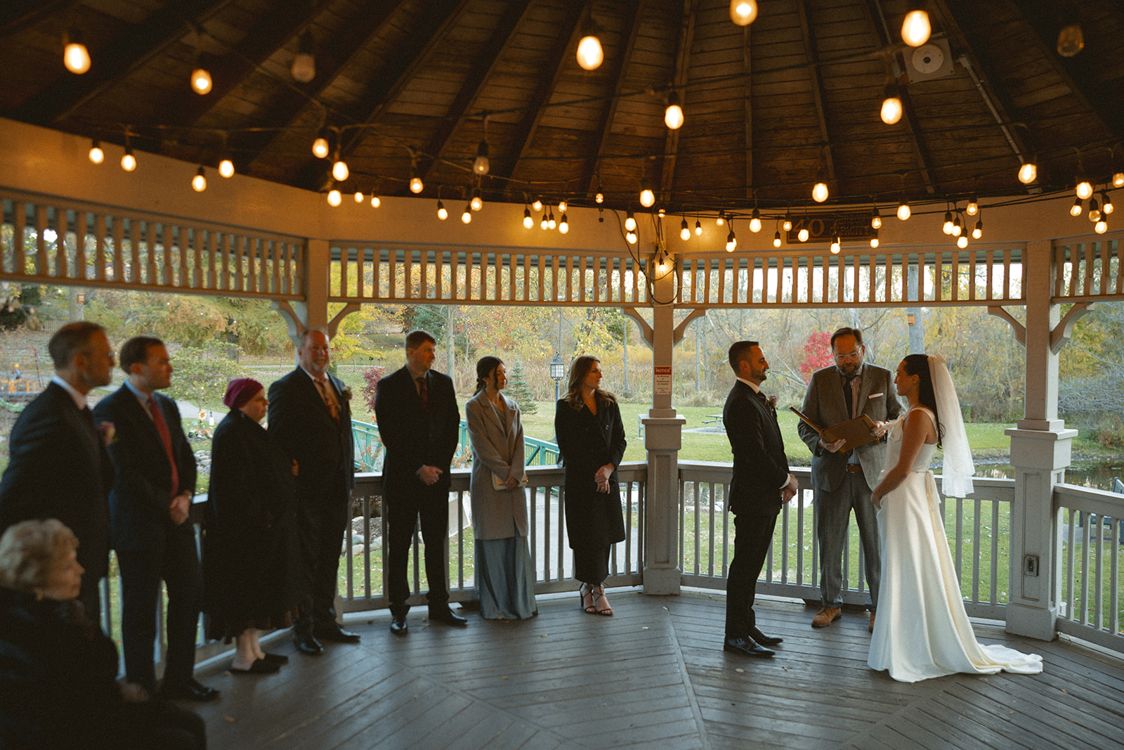 Bride and groom standing together during intimate outdoor ceremony at Depot Park in Clarkston Michigan.