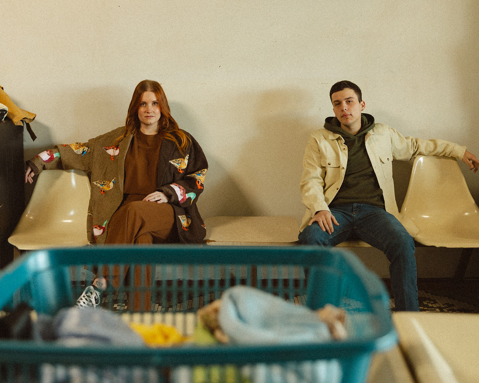Couple posing together at a vintage laundromat in Michigan.