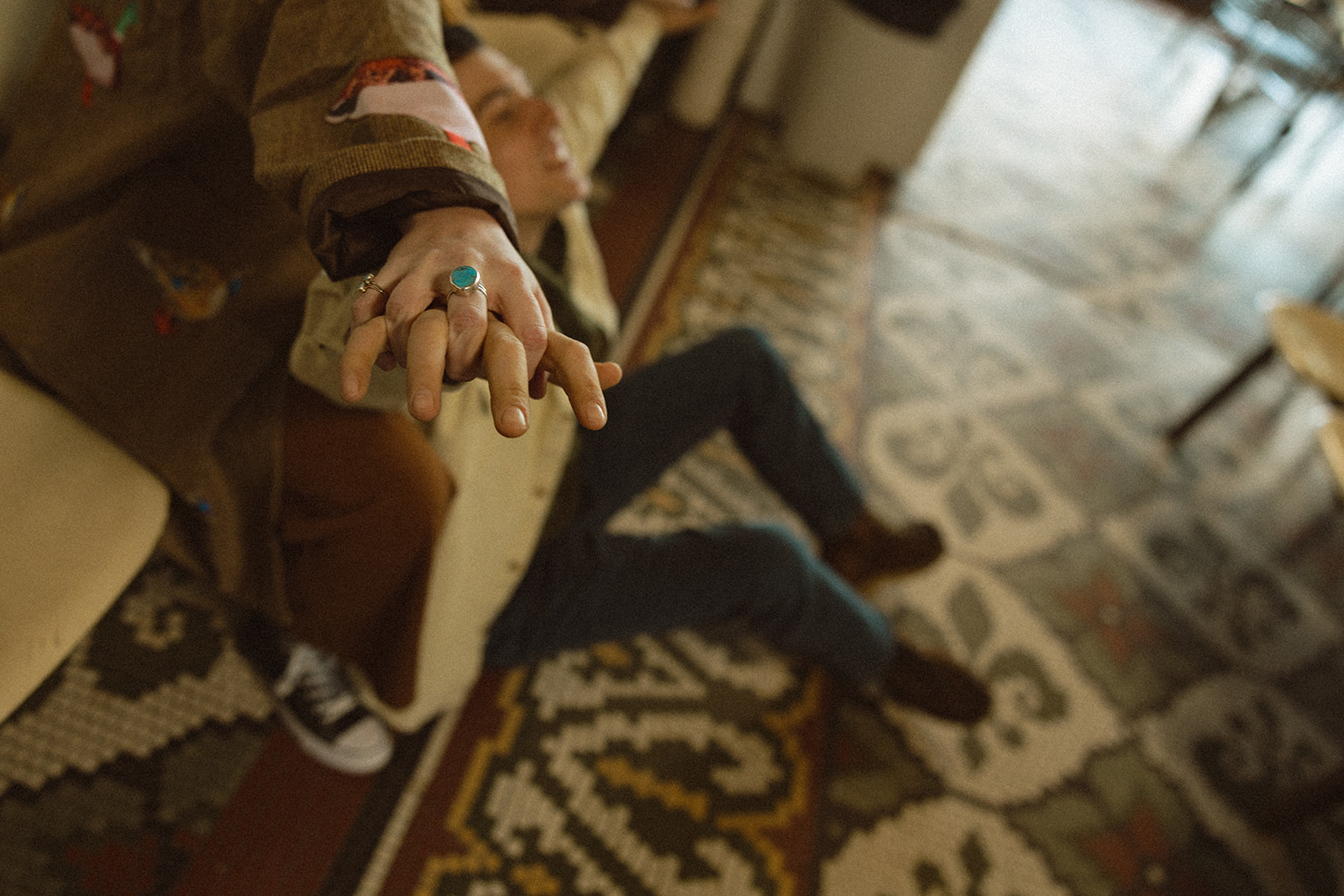Couple holding hands during their laundromat photoshoot in Michigan.