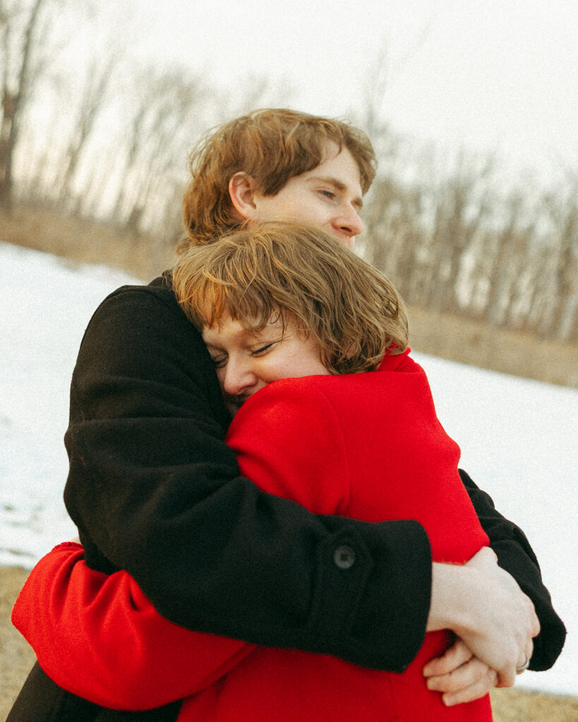 Couple hugging each other during wintertime.