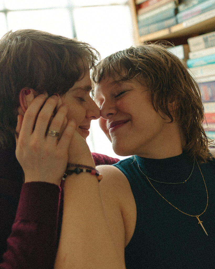 Close up photo of a couple cuddling up to one another.